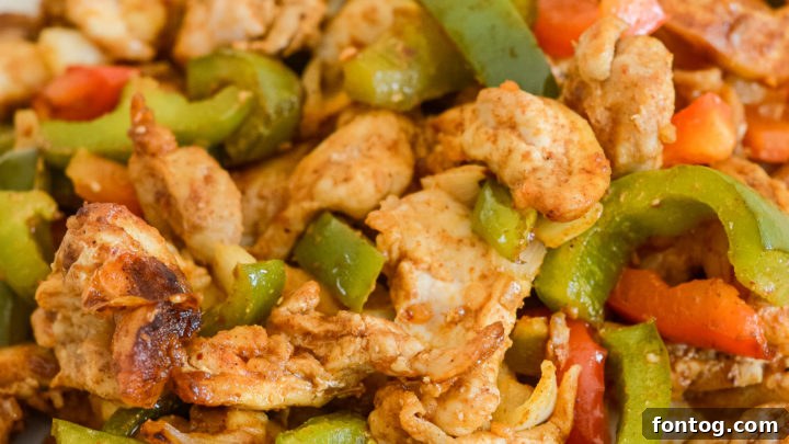 Sizzling chicken fajitas with colorful peppers and onions, cooked in an air fryer.