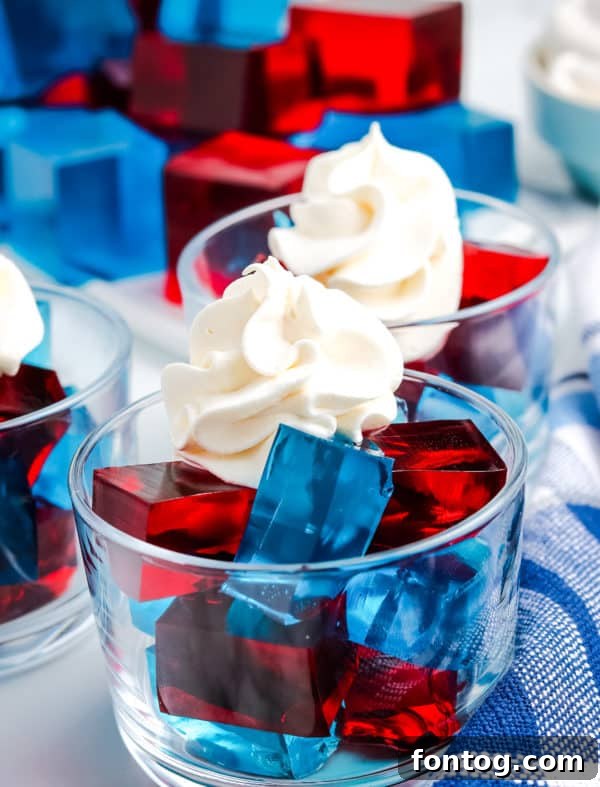 Vibrant red and blue Patriotic Jello Jigglers cubes arranged beautifully on a serving dish, perfect for summer holidays.