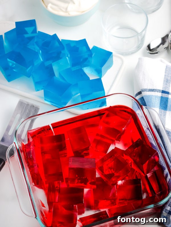 Layers of distinct red and blue Jello Jigglers in a glass dish, showcasing the patriotic color scheme.