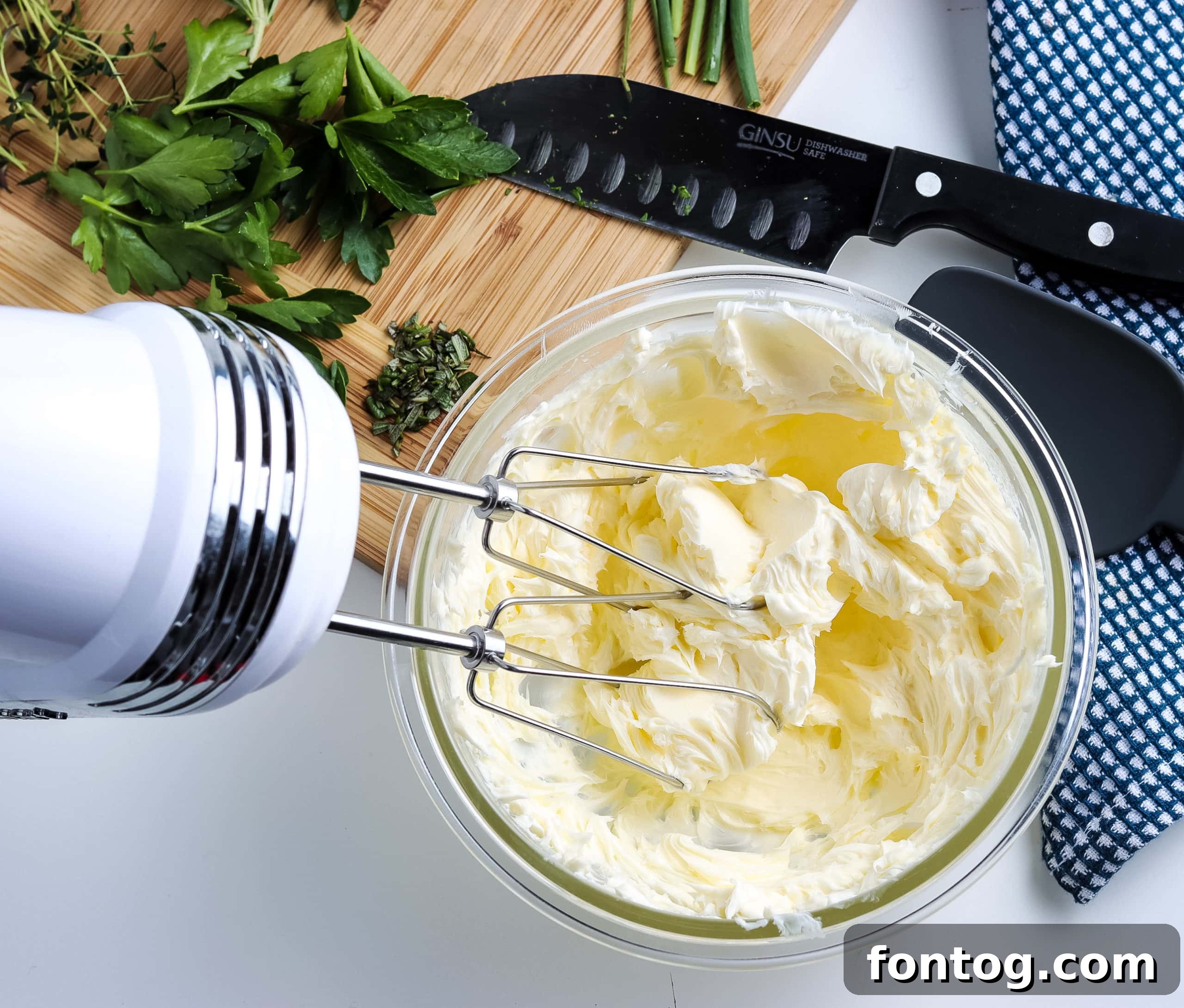 Close-up of Fresh Herb Butter (Compound Butter) in a small dish, with a sprig of rosemary