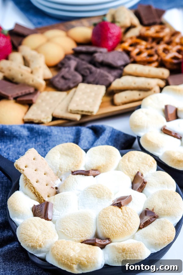 Effortless S'mores Treat 2 Delicious S'mores Dip in a cast iron skillet, ready to be served