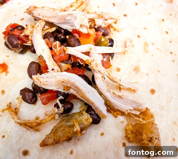 Preparing the chicken filling for Ninja Foodi Chicken Enchiladas.