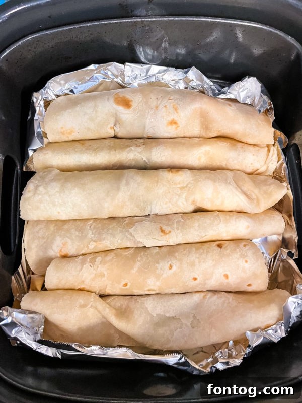 Assembling Ninja Foodi Chicken Enchiladas with a variety of fillings.