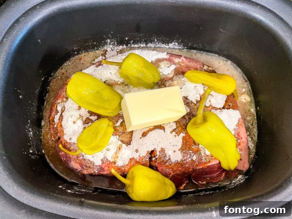 Slow Cooker Mississippi Pot Roast cooking in a slow cooker