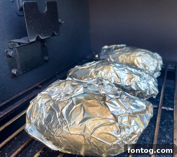 smoked baked potatoes on the grill