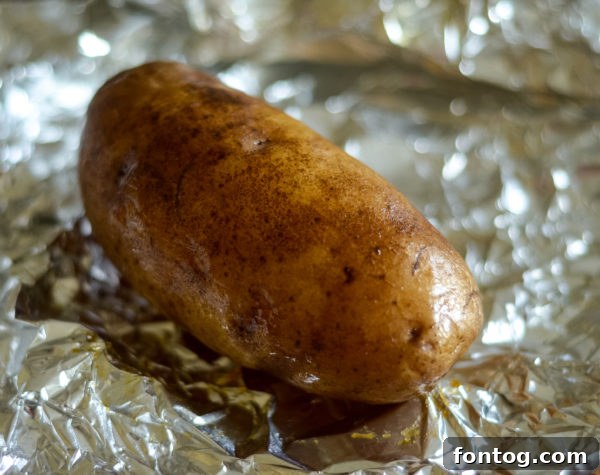 close-up of wrapped smoked baked potatoes