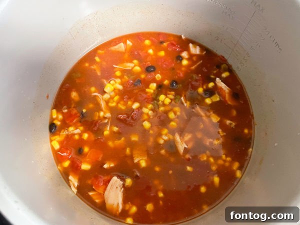Close-up of Ninja Foodi pot with soup mixture before pressure cooking.