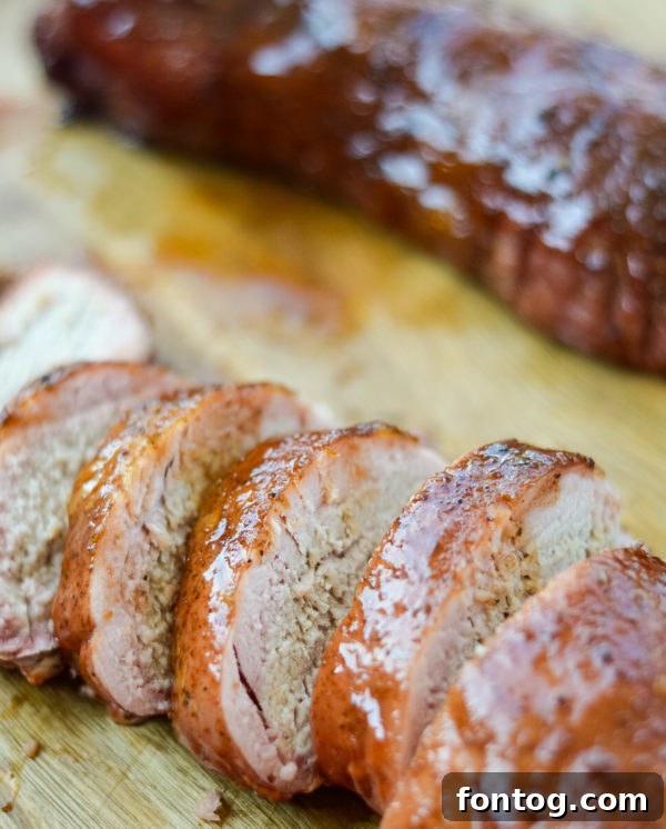 Perfectly smoked pork tenderloin, sliced and ready to serve