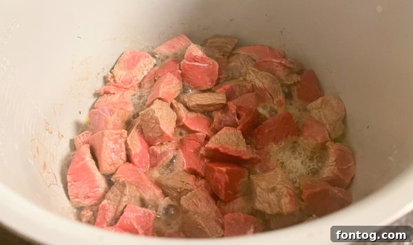 close-up of raw sirloin steak cut into chunks, ready for cooking