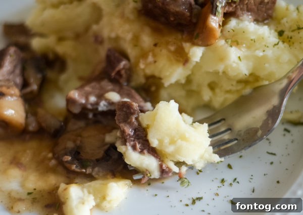 plated Ninja Foodi beef tips with parsley garnish, ready to be enjoyed