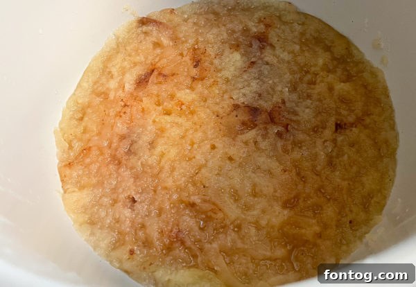 Peeled and sliced apples mixed with brown sugar, cinnamon, and nutmeg in the Ninja Foodi pot.