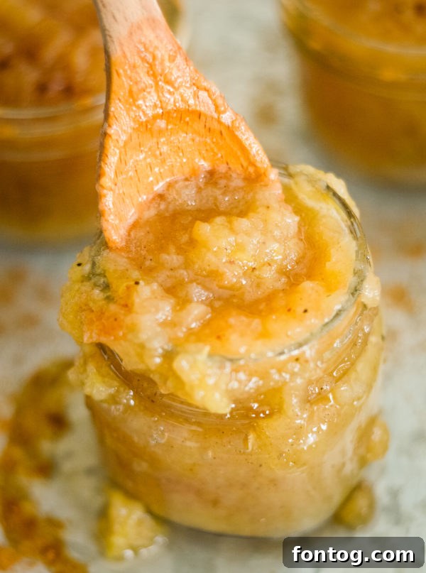 Bowl of freshly made Ninja Foodi applesauce with a spoon, ready to be enjoyed.