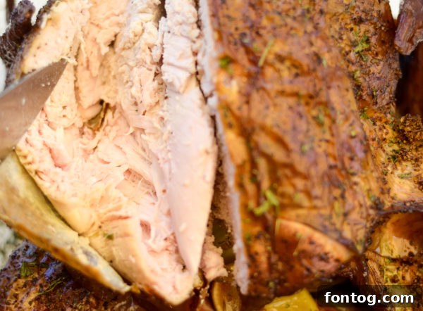 Close-up of a seasoned whole turkey, ready for the pellet grill.