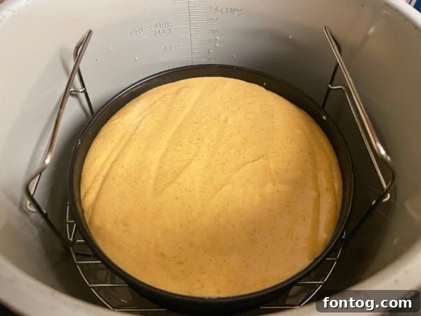 Close-up of creamy pumpkin cheesecake batter being prepared