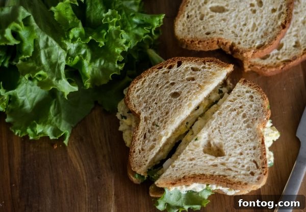 Peeled hard-boiled eggs in a bowl, ready for mashing for egg salad