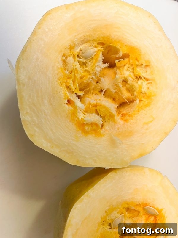 Perfect Spaghetti Squash in Your Ninja Foodi 4 scooping seeds from ninja foodi spaghetti squash