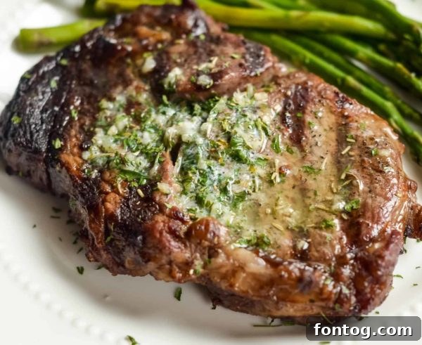 Garlic Butter Ribeyes sizzling on the grill, a perfect main course
