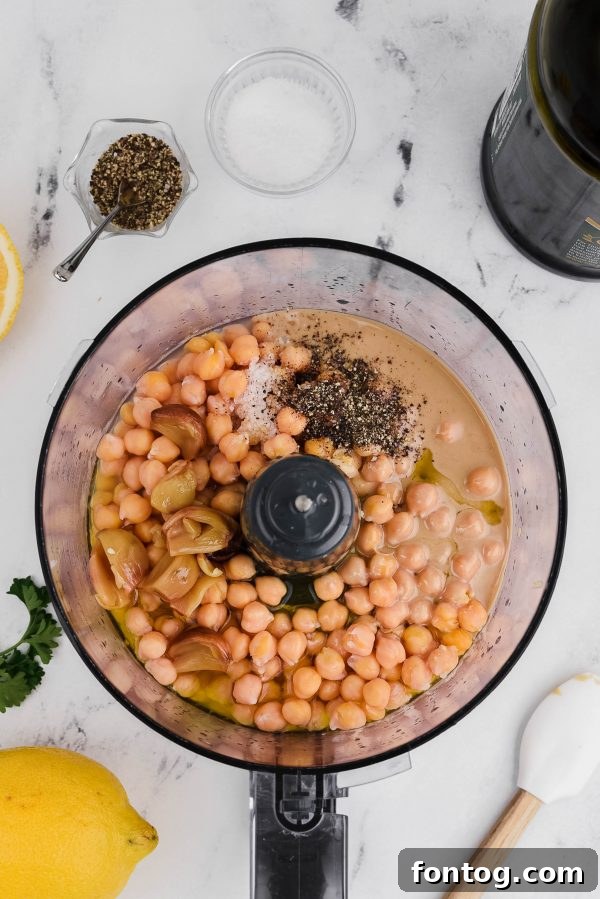 Bowls of dried chickpeas and tahini paste, illustrating the main components of hummus.