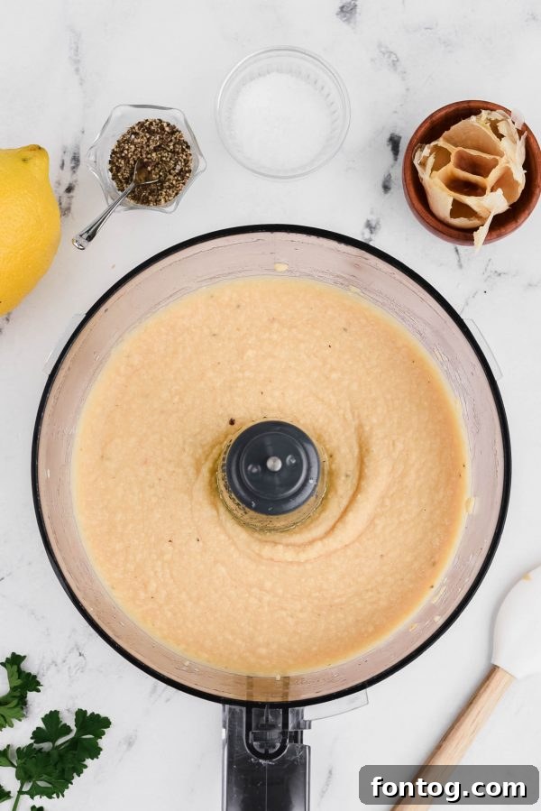 Open can of chickpeas, illustrating the convenient form often used for hummus recipes.