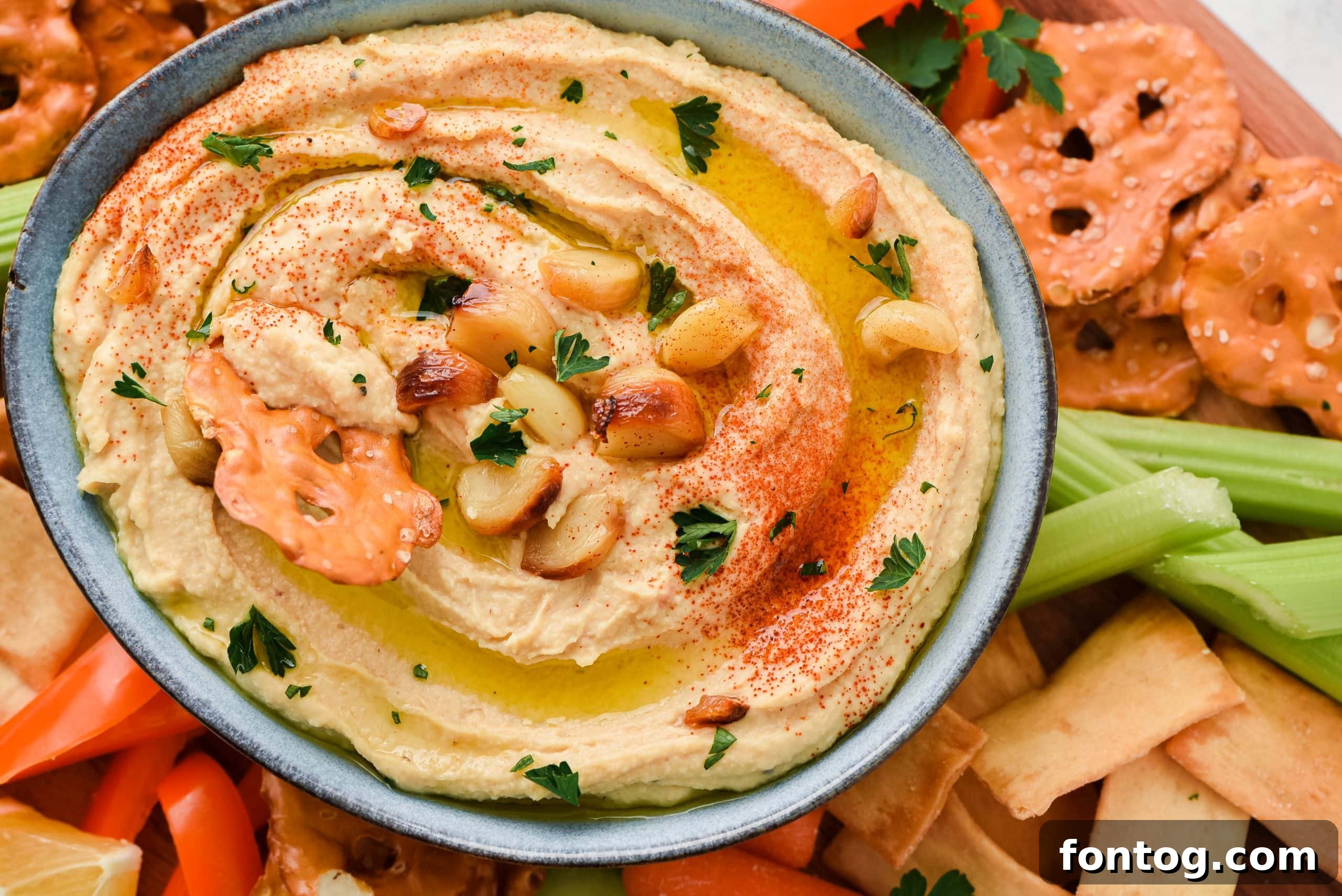 Roasted Garlic Hummus in a bowl, showing a portion of the finished product.