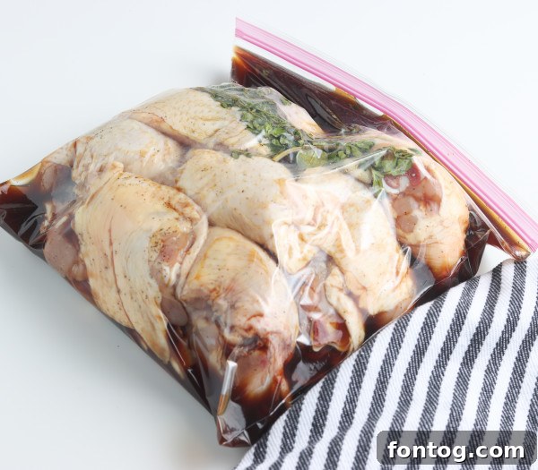 Smoked chicken thighs resting after coming off the pellet grill, showing their deep color.