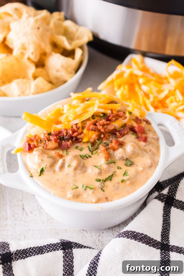 Creamy Ninja Foodi Cheese Dip 2 Ninja Foodi Cheeseburger Dip served hot in a Ninja Foodi pot, garnished with fresh herbs.