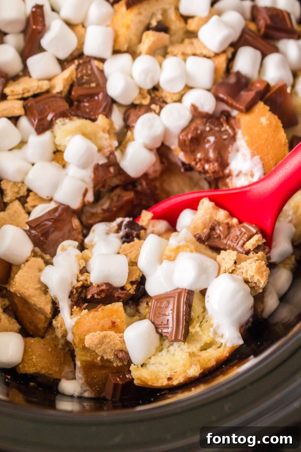 Delicious Slow Cooker S'mores French Toast Casserole ready to serve, topped with melted chocolate and golden marshmallows.