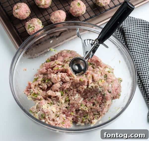 Ingredients for smoked meatballs being prepared, including fresh ground meat and seasonings
