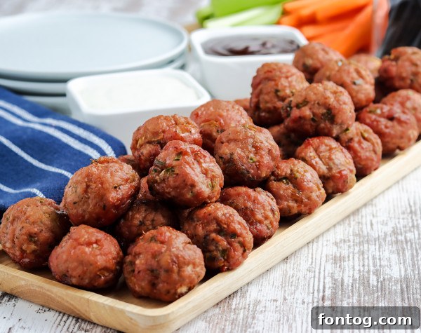 Platter of perfectly smoked meatballs, garnished and ready to serve