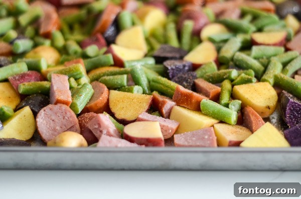 Effortless Sausage and Veggie Sheet Pan Dinner 3 Sliced smoked sausage and baby potatoes on a baking sheet