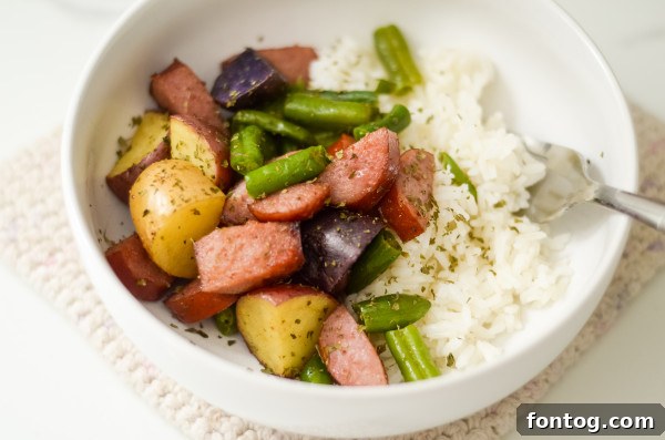 Effortless Sausage and Veggie Sheet Pan Dinner 6 Plated sheet pan sausage and vegetables with a fork