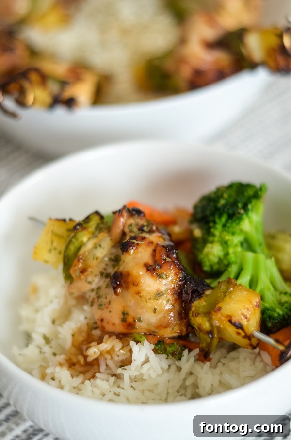 Ninja Foodi Sweet and Sour Chicken Skewers: Juicy chicken and vibrant vegetables on skewers, coated in a glistening sweet and sour sauce, ready to be air-fried to perfection in a Ninja Foodi.