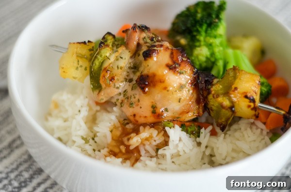 Boneless, Skinless Chicken Thighs: Raw, diced boneless, skinless chicken thighs on a cutting board, ready for skewer preparation.