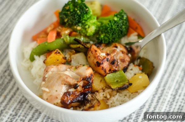 Prepared Sweet and Sour Chicken Skewers: Cooked chicken and vegetable skewers, glistening with sauce, served on a plate.