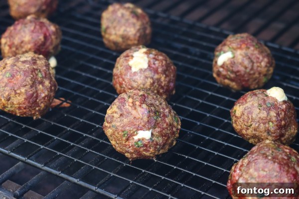 Smoked Stuffed Meatballs on a grill rack