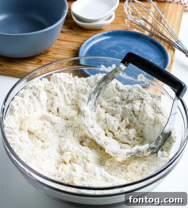 Two hands scooping gluten-free baking mix from a large bowl