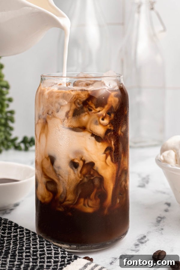 Elevate Your Coffee Experience 5 best coffee drink recipes: Iced mocha in a clear glass with chocolate drizzle