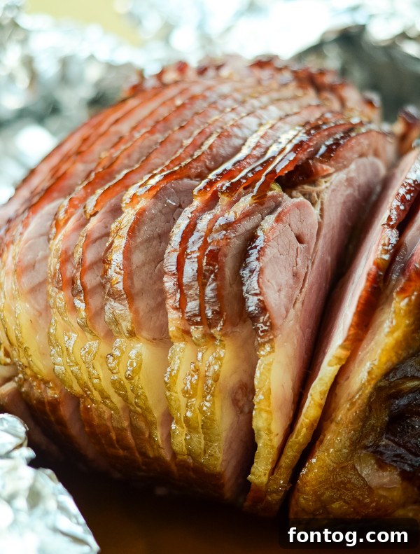 Succulent double-smoked ham fresh off the pellet grill, ready for carving.