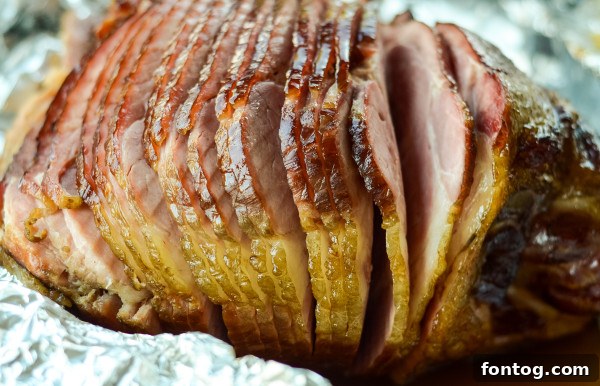 Close-up of a serving of smoked ham with a rich, glossy glaze.