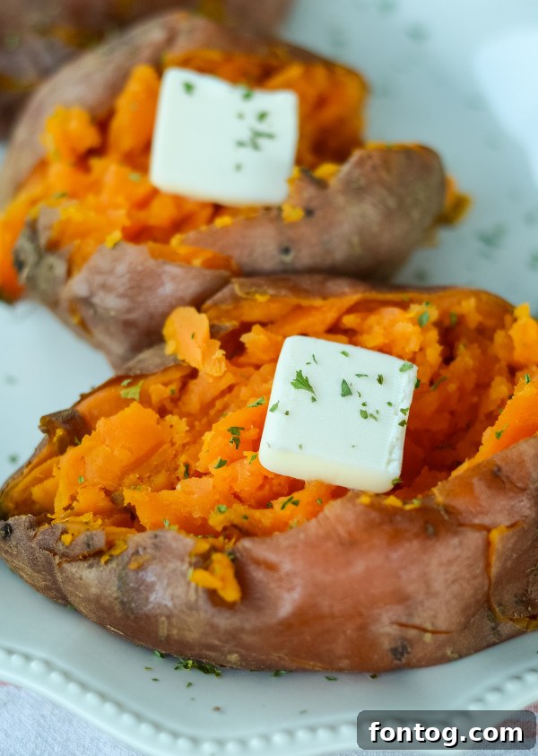 Ultimate Pellet Grill Smoked Sweet Potatoes 6 An open smoked sweet potato topped with melted butter, brown sugar, and cinnamon, ready to be enjoyed.