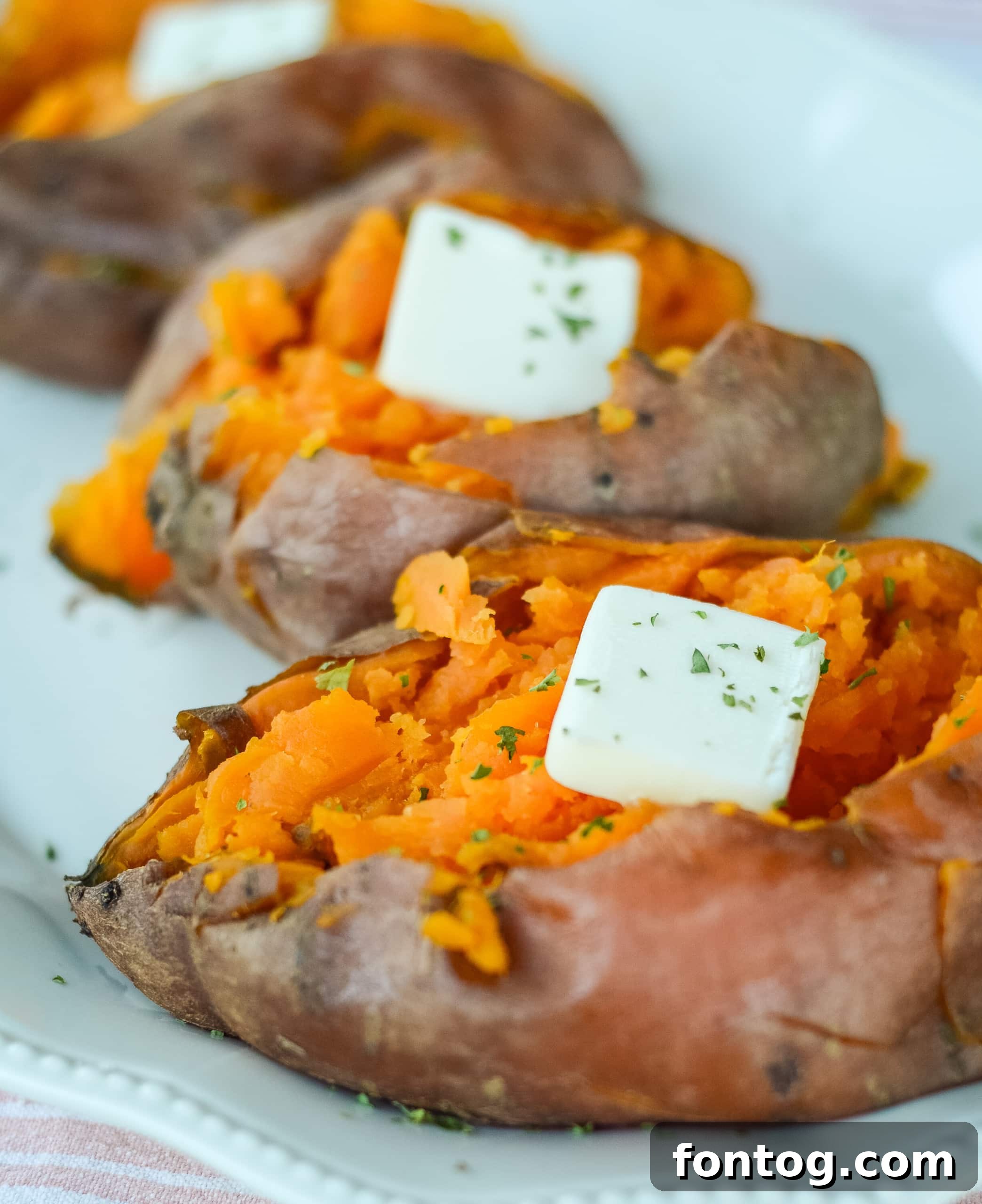 Ultimate Pellet Grill Smoked Sweet Potatoes 8 A close-up of a perfectly smoked sweet potato, sliced open and ready for toppings, showcasing its tender texture.