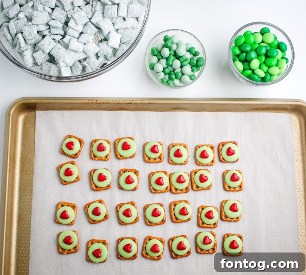 Grinch Pretzel Bites displayed in a clear jar, indicating they are perfect for gifting or storing for later enjoyment.
