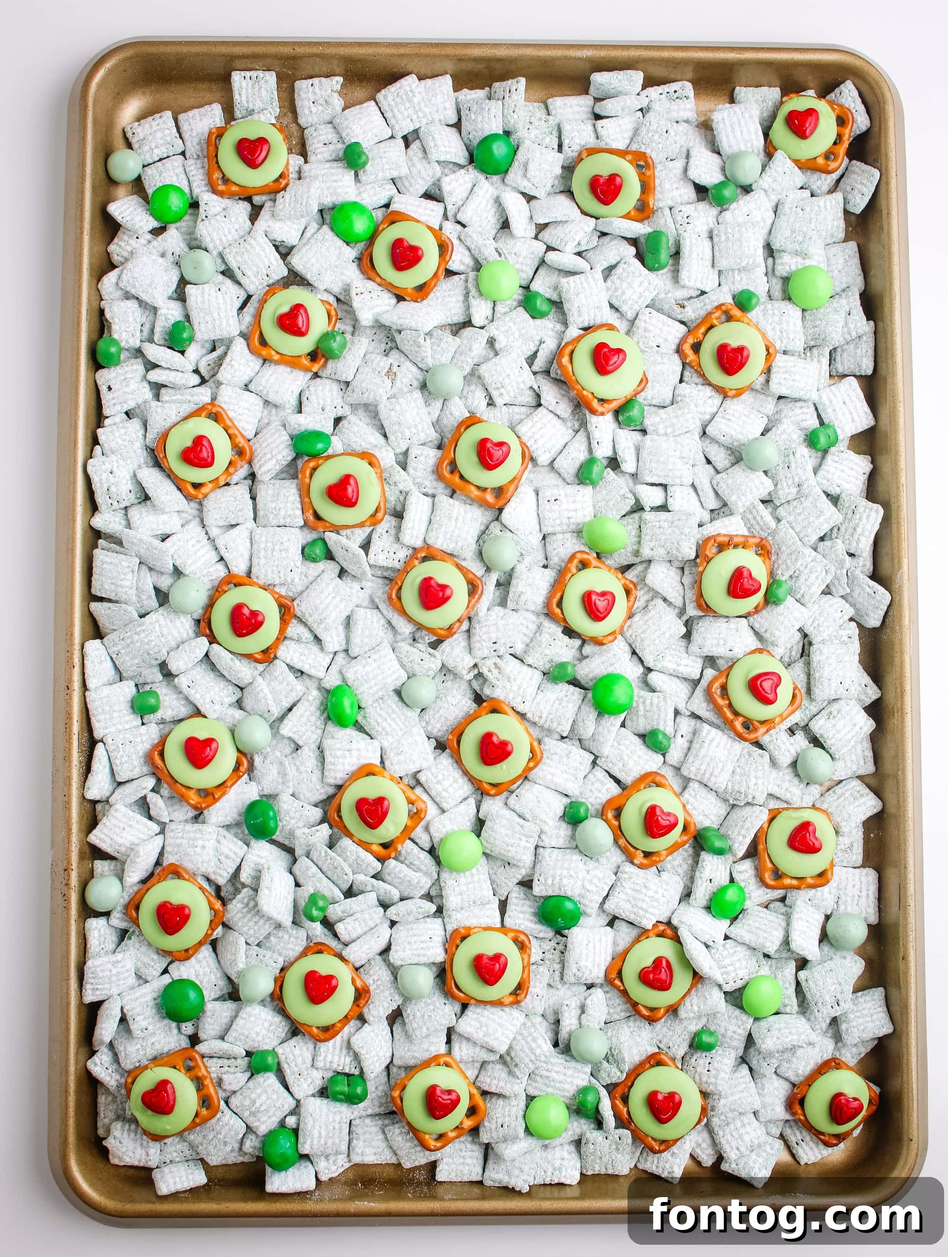 Grinch Pretzel Bites with green candy and red heart