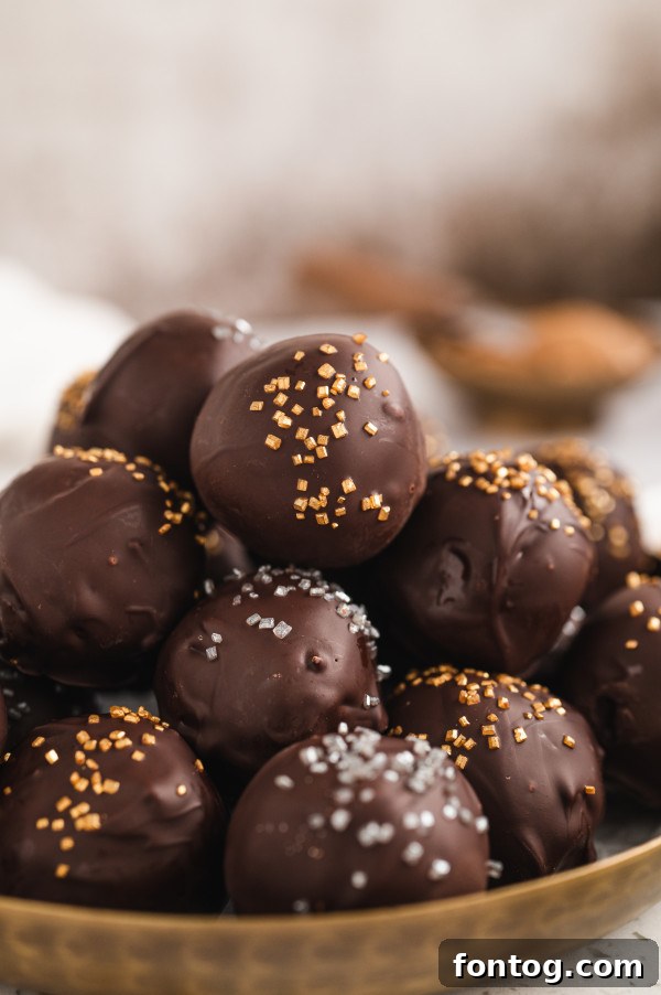 Decadent gluten-free no-bake truffles with a chocolate coating and sprinkles, perfect for any occasion.
