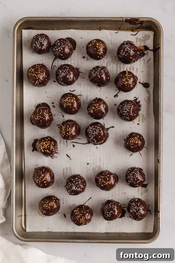 Close-up of a perfectly dipped gluten-free truffle with sprinkles.