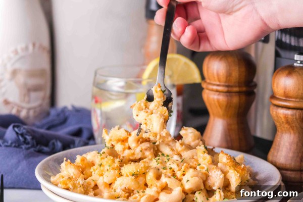 Ninja Foodi Buffalo Macaroni and Cheese with a spoon, highlighting its texture.