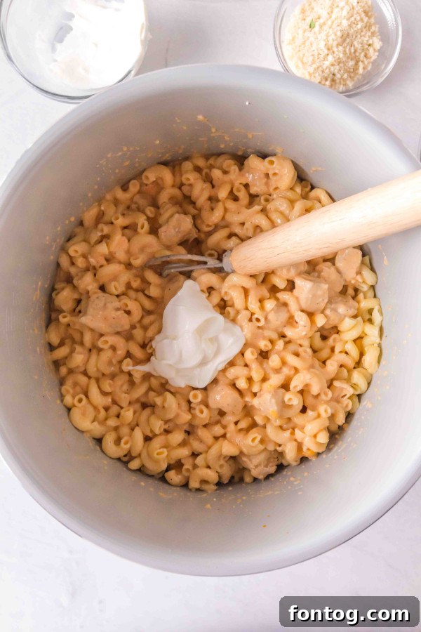 The buffalo chicken mac and cheese cooking in the Ninja Foodi pot, with the air fryer lid on.