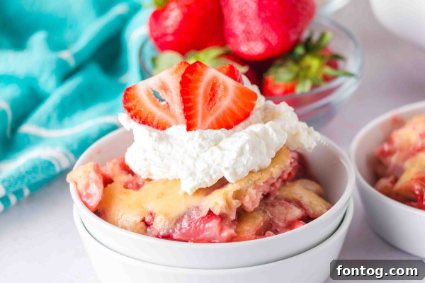 gluten-free strawberry cobbler served with whipped cream