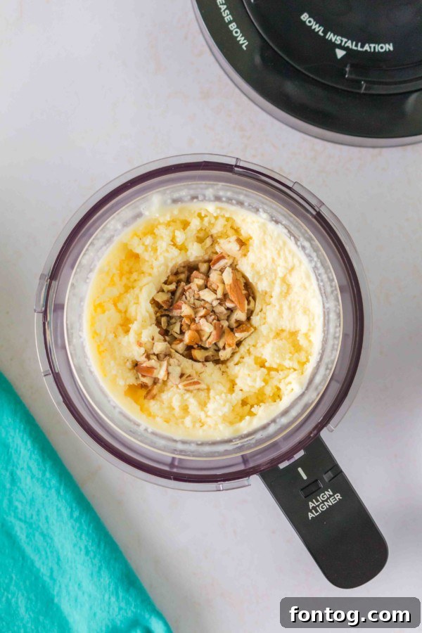 Ninja Creami Butter Pecan Bliss 8 Adding chopped pecans to Ninja Creami ice cream