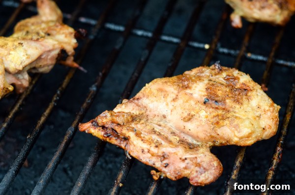 Chicken thighs coated with seasoning and cornstarch, ready for grill
